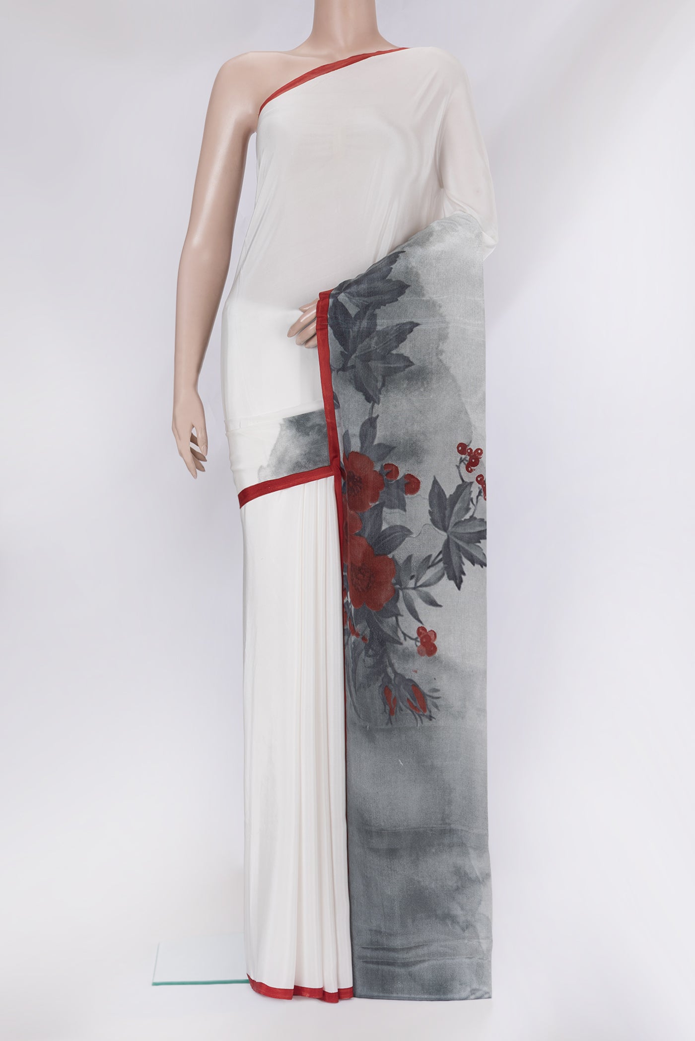 White Crepe Saree with Printed design on the body and Fancy Border.  displayed on a mannequin