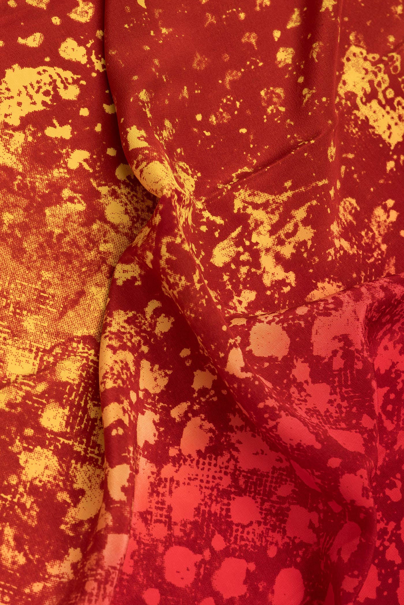 Close up of Red Dual Tone Mysore Crepe Saree with Printed design on the body and Without Border.  displaying folds