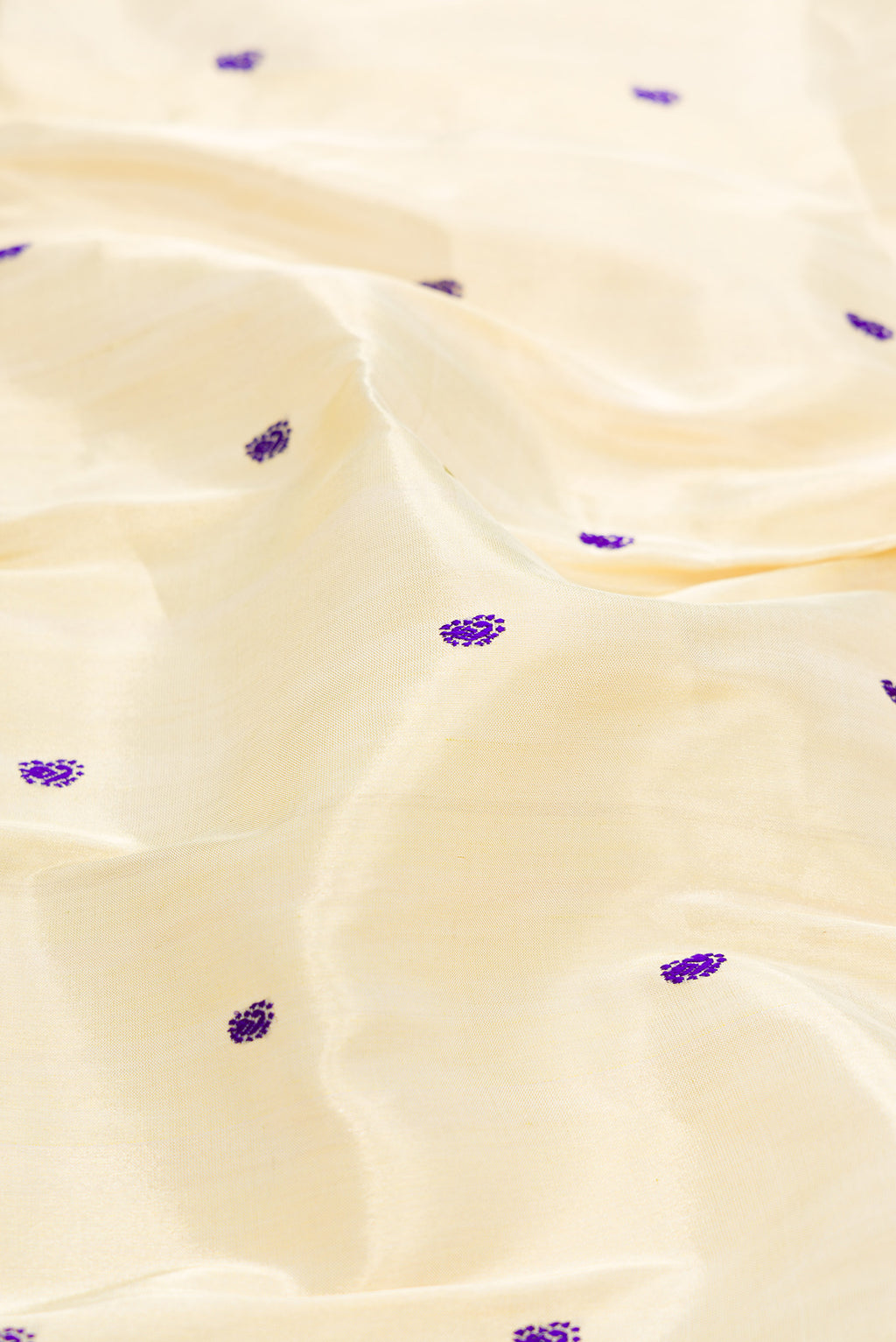 Close up of Gold Dual Tone Paithani Silk Saree with Thread Butta on the body and Paithani Border.  displaying folds