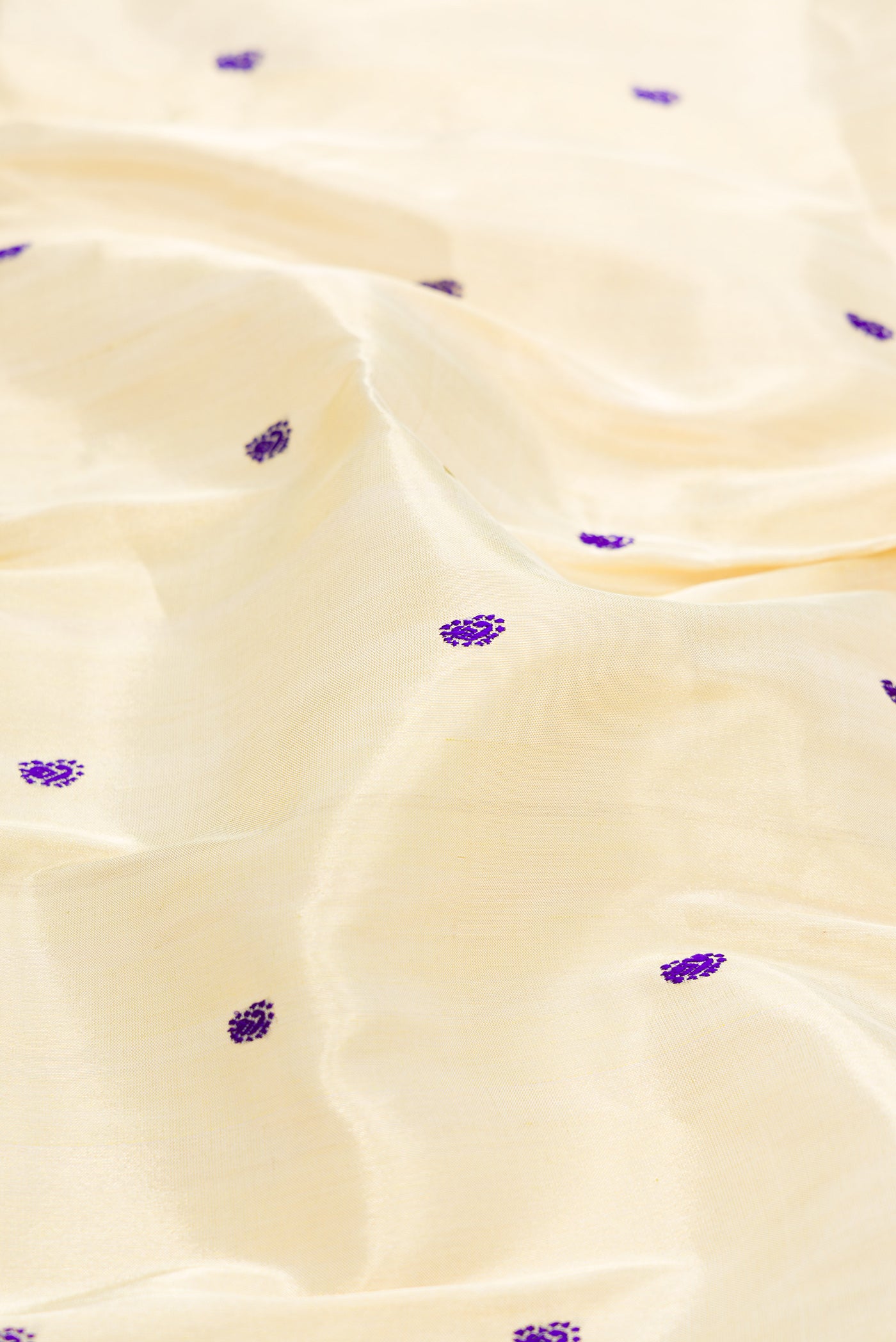 Close up of Gold Dual Tone Paithani Silk Saree with Thread Butta on the body and Paithani Border.  displaying folds