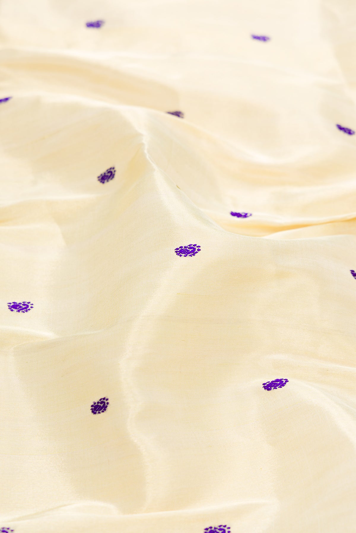 Close up of Gold Dual Tone Paithani Silk Saree with Thread Butta on the body and Paithani Border.  displaying folds