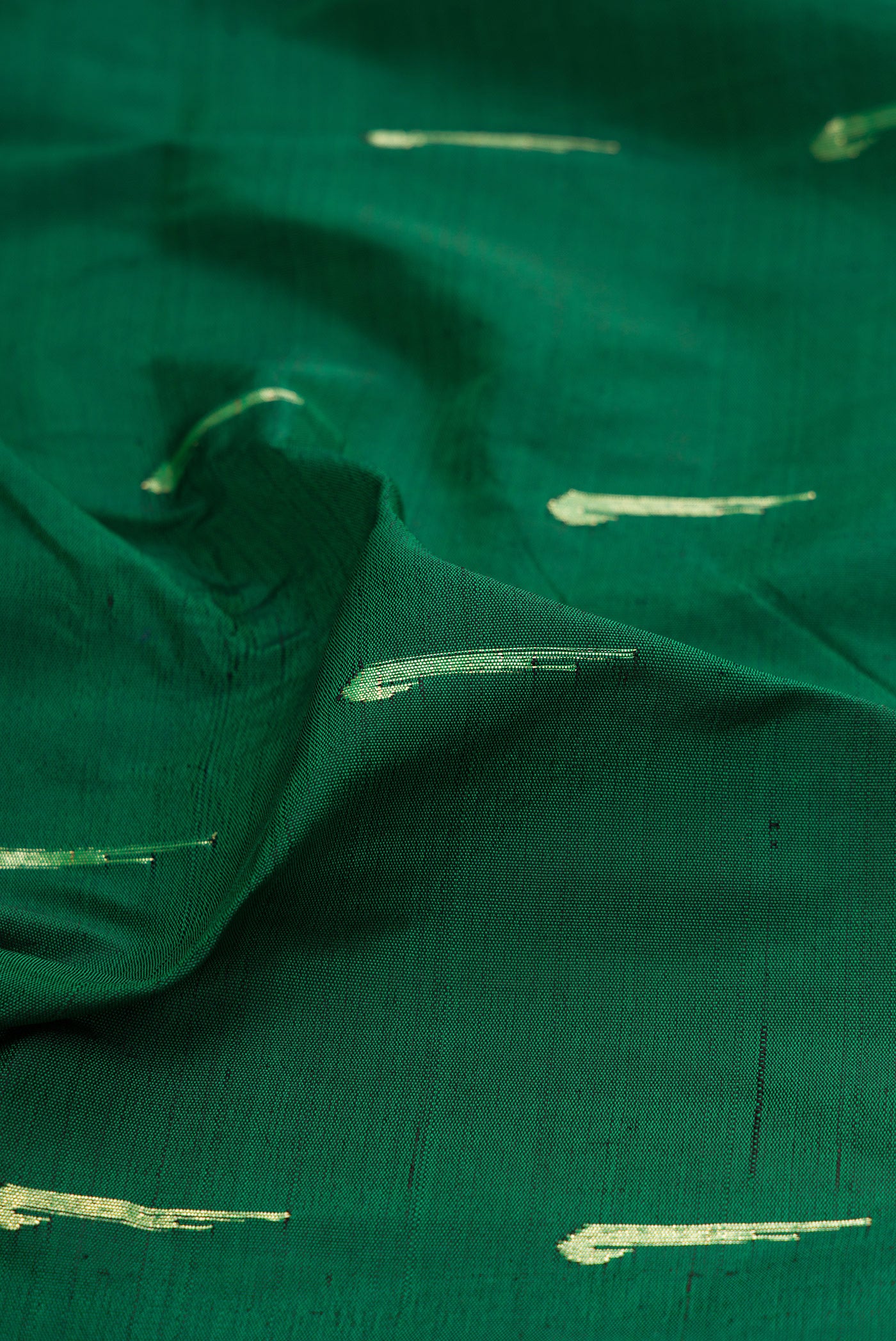 Close up of Bottle Green Paithani Silk Saree with Zari Butta on the body and Paithani Border.  displaying folds