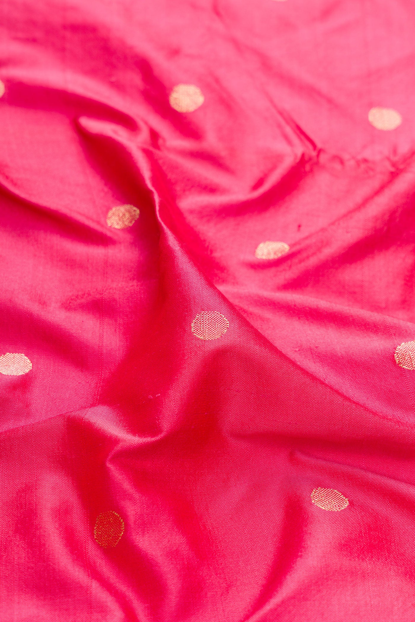 Close up of Pink Dual Tone Paithani Silk Saree with Zari Butta on the body and Paithani Border.  displaying folds