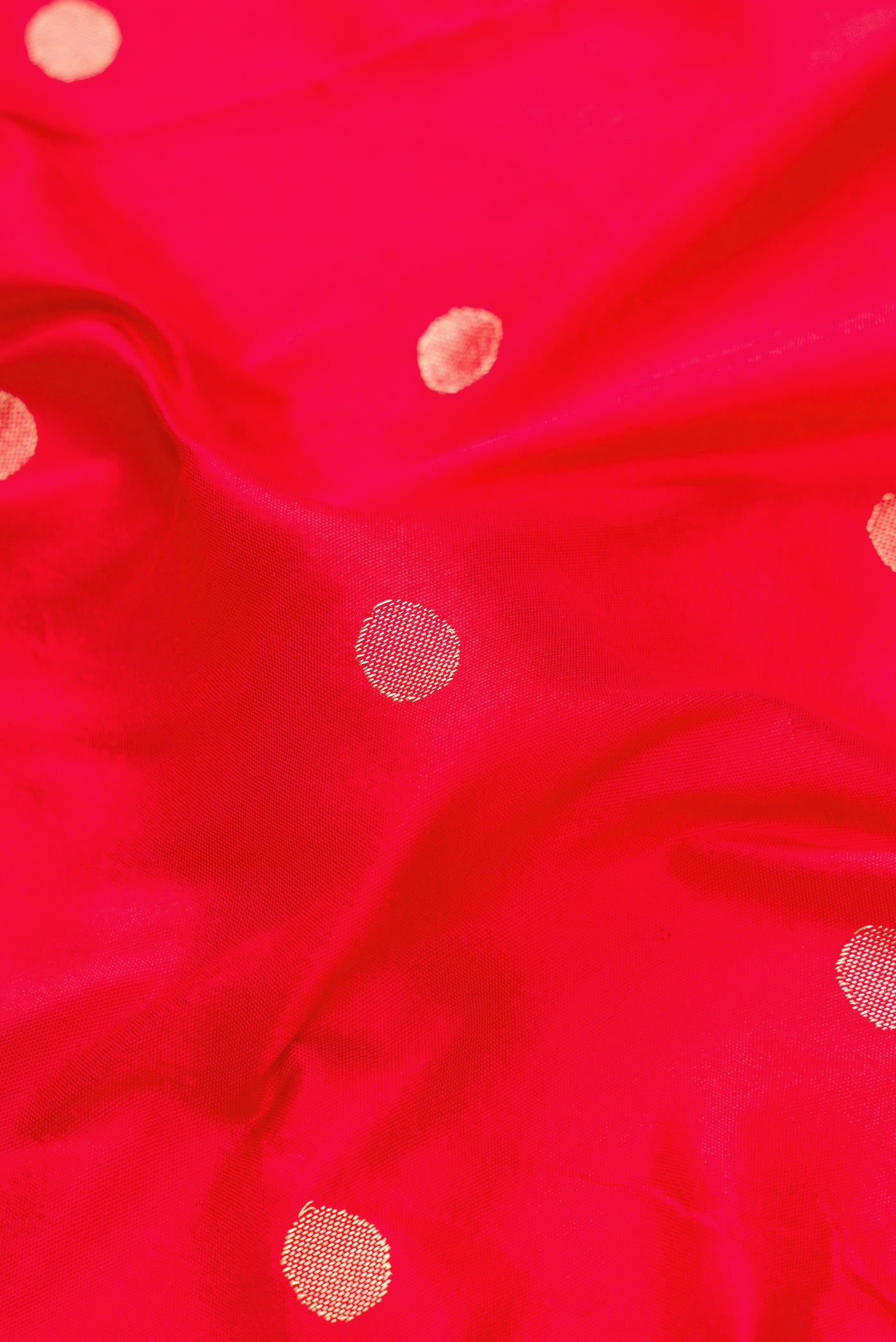 Close up of Red Dual Tone Paithani Silk Saree with Zari Butta on the body and Paithani Border.  displaying folds