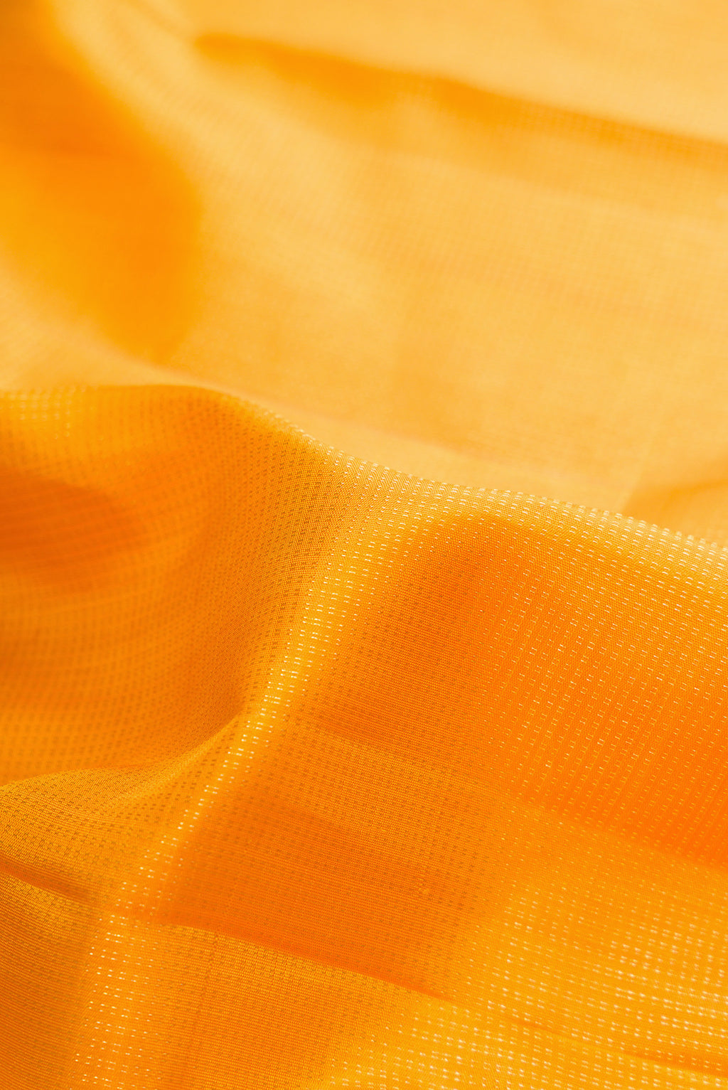 Close up of Pure Silk Mustard Kanchipuram Saree with Stripes on the body and Zari Border.  displaying folds