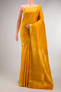 Pure Silk Mustard Kanchipuram Saree with Stripes on the body and Zari Border.  displayed on a mannequin