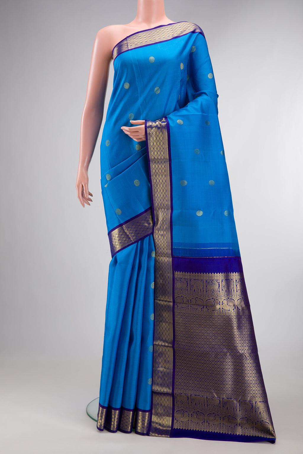 Pure Silk Sky Blue Kanjivaram Saree with Zari Butta on the body and Zari Border.  displayed on a mannequin