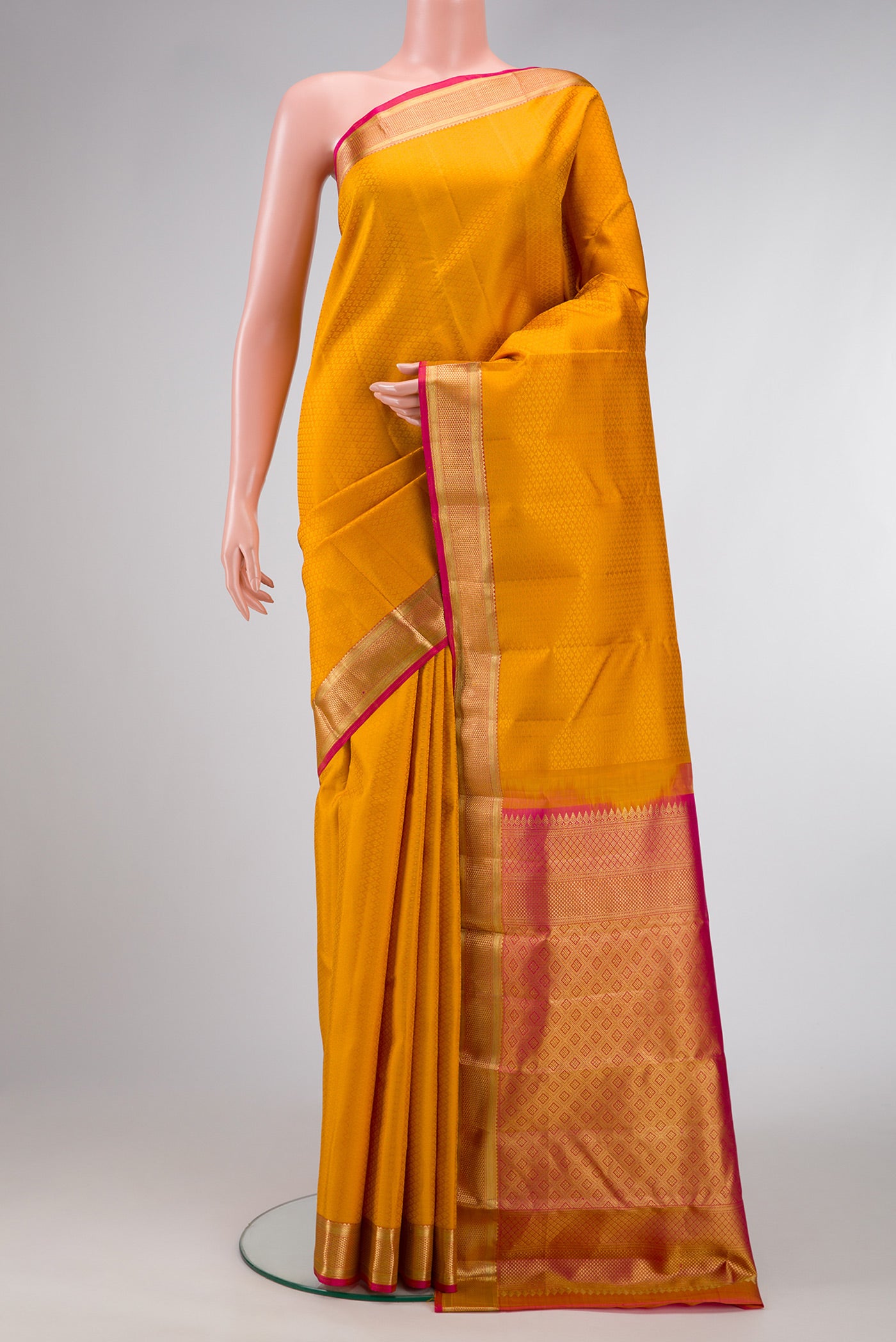 Mustard Dual Tone Kanjivaram Silk Saree with Jacquard design on the body and Zari Border.  displayed on a mannequin