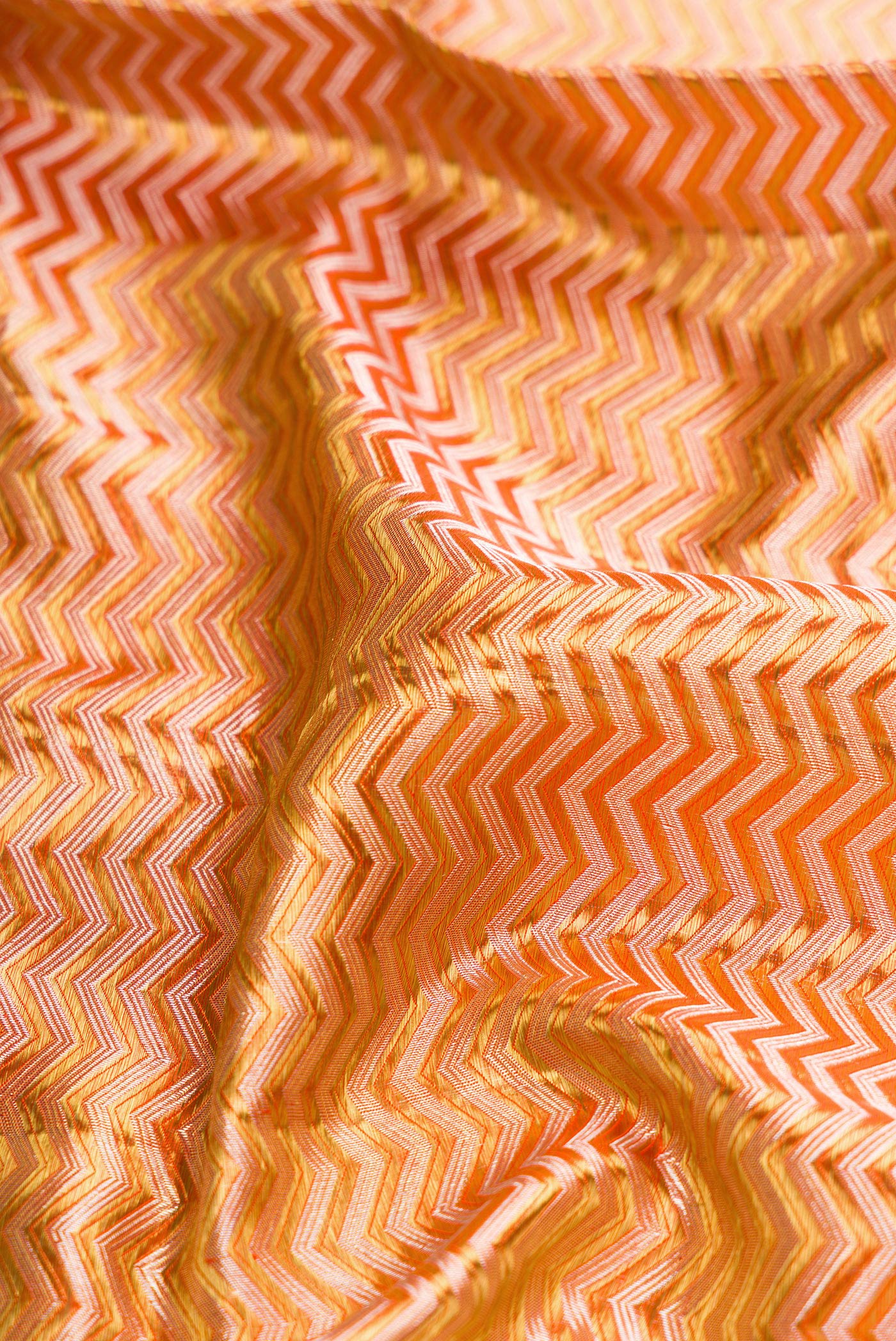 Close up of Gold Dual Tone Kanjivaram Tissue Silk Saree with Zari Brocade on the body and Zari Border.  displaying folds