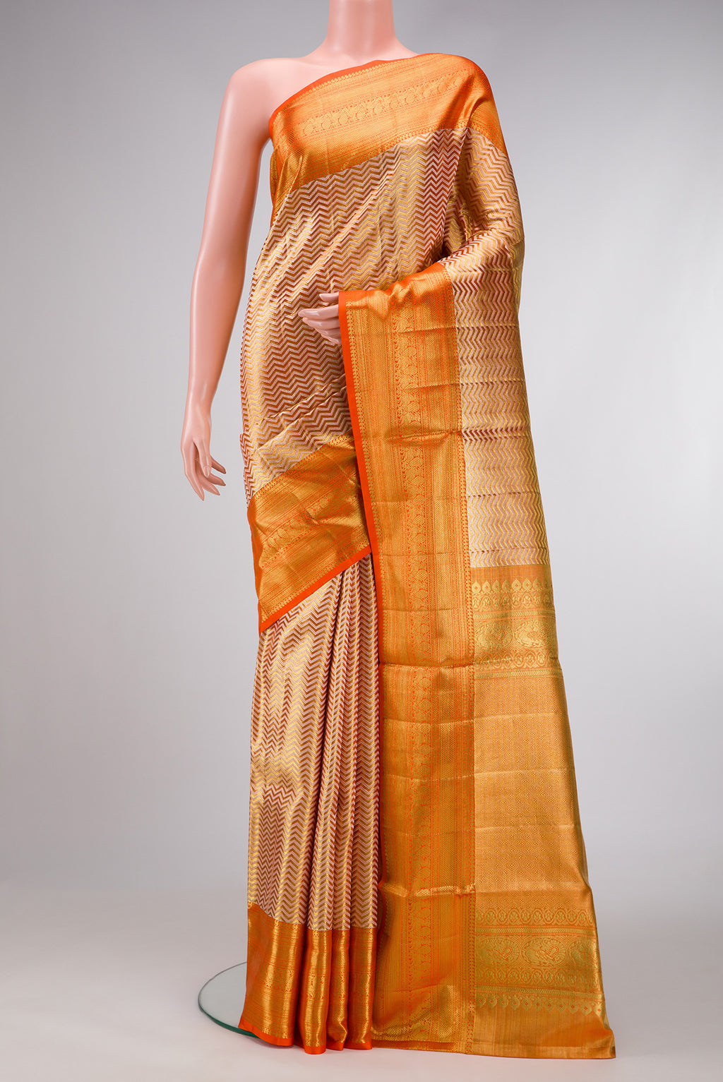 Gold Dual Tone Kanjivaram Tissue Silk Saree with Zari Brocade on the body and Zari Border.  displayed on a mannequin