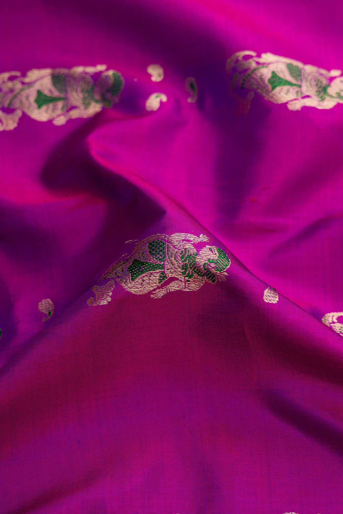 Close up of Purple Dual Tone Baluchari Silk Saree with Zari And Thread Butta on the body and Zari Border.  displaying folds