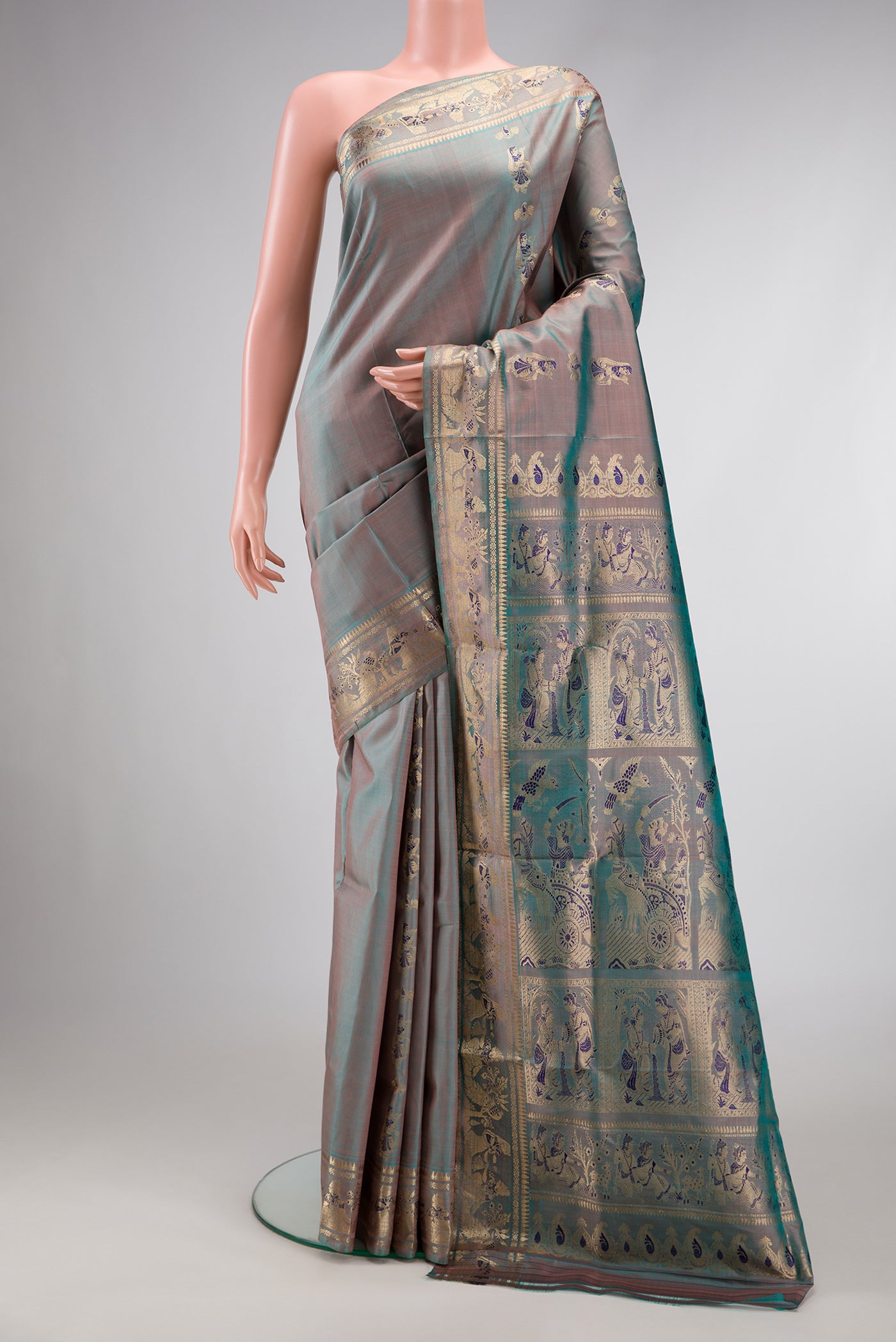 Blue Grey Dual Tone Baluchari Silk Saree with Zari And Thread Butta on the body and Fancy Border.  displayed on a mannequin