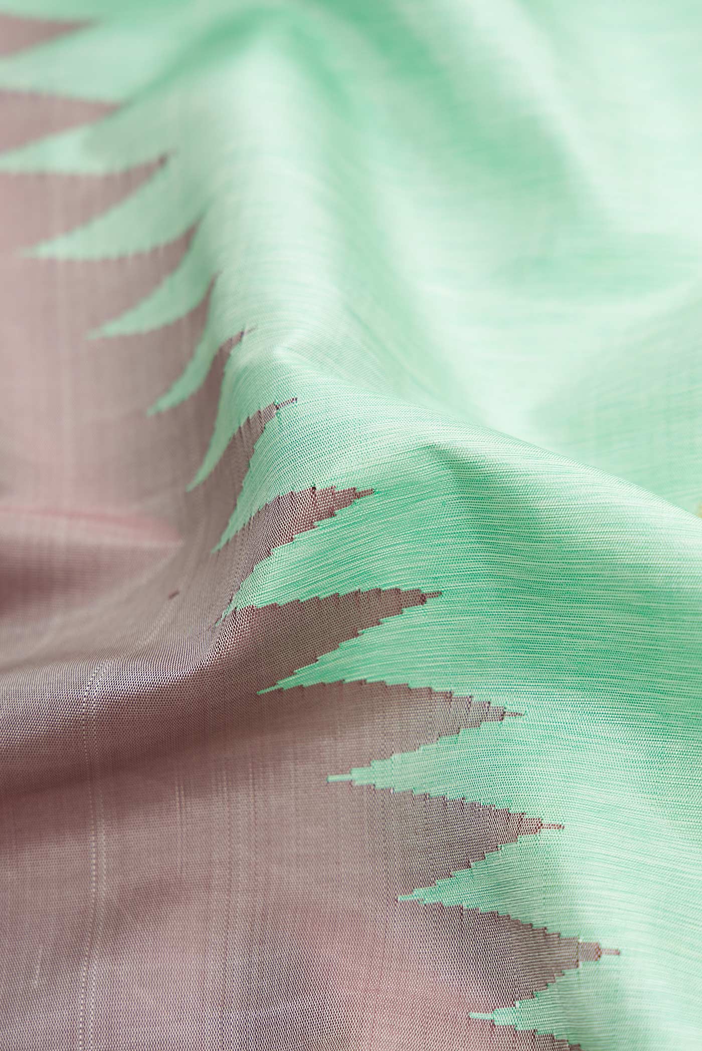 Close up of Pure Silk Pure Zari Sea Green Kanchipuram Saree with Zari Butta on the body and Rising Temple Border displaying folds