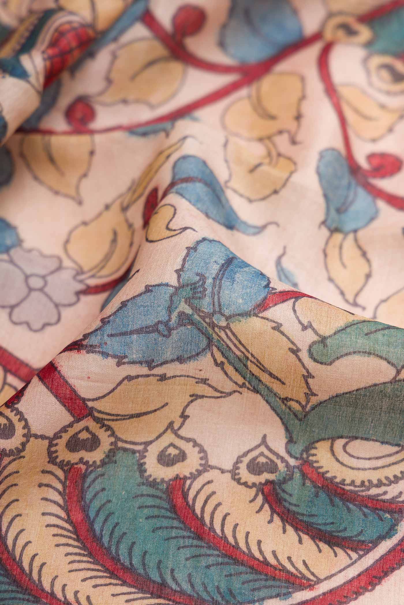 Close up of Rose Gold Dual Tone Tussar Silk Saree with kalamkari Print on the body and Fancy Border.  displaying folds