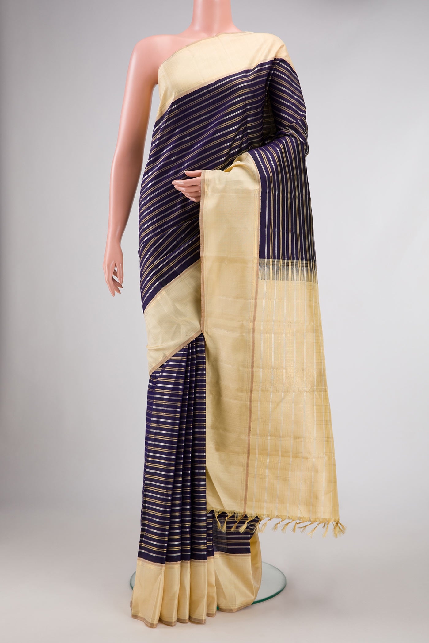 Navy Blue Dual Tone Kanchipuram Silk Saree with Stripes on the body and Zari Border.  displayed on a mannequin