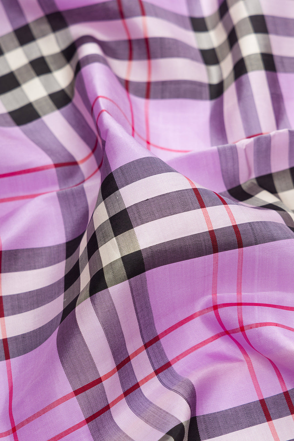 Close up of Pure Silk Pure Zari Lavender Kanjivaram Saree with Checked design on the body and Fancy Border.  displaying folds
