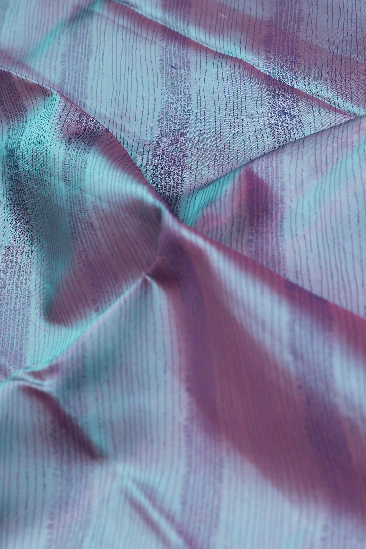 Close up of Peacock Blue Dual Tone Kanchipuram Silk Saree with Jacquard design on the body and Thread Border.  displaying folds