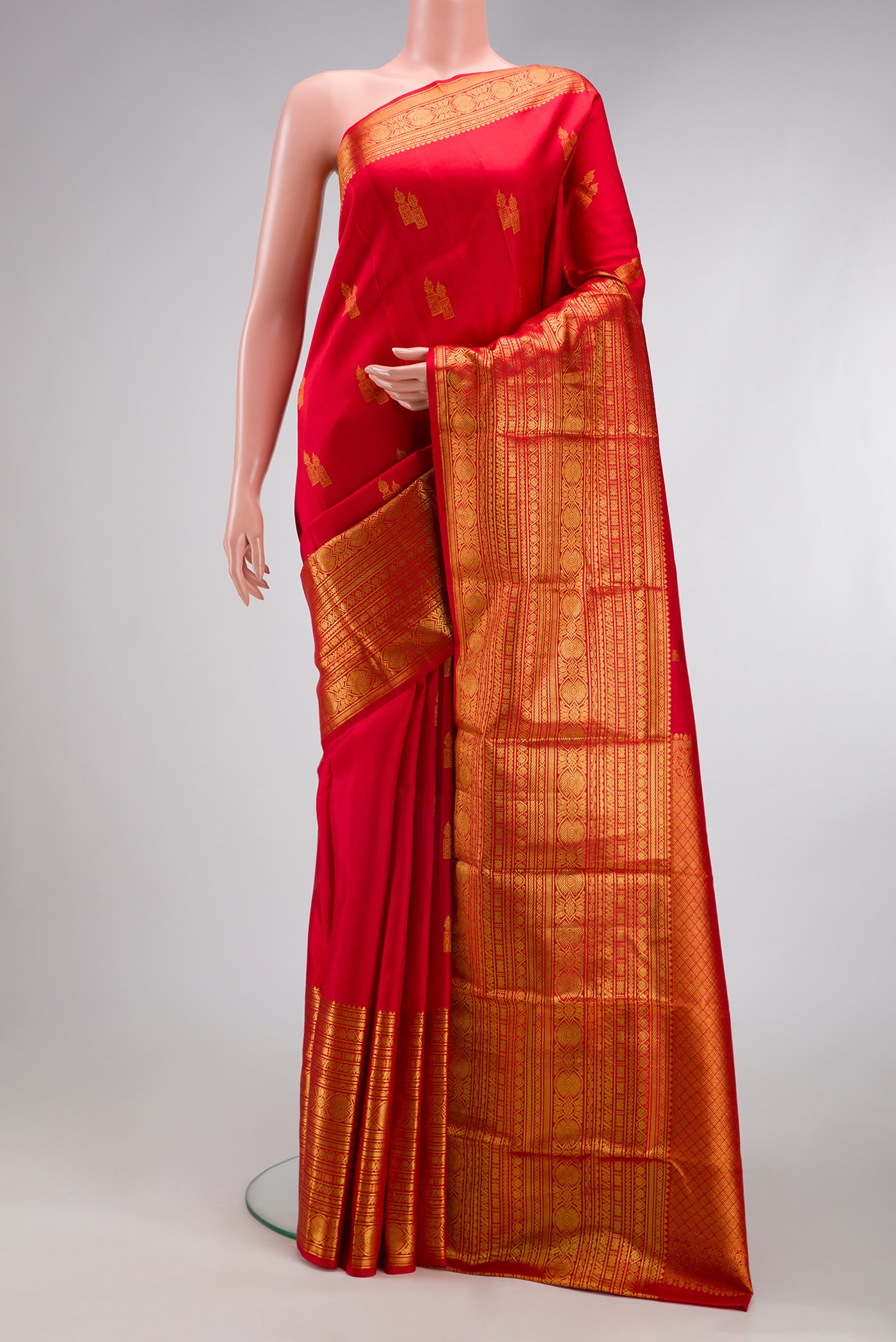 Red Kanchipuram Silk Saree with Zari Butta on the body and Zari Border.  displayed on a mannequin