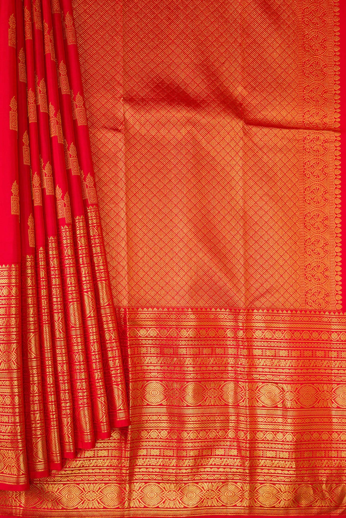 Pleats and pallu of Red Kanchipuram Silk Saree with Zari Butta on the body and Zari Border. 