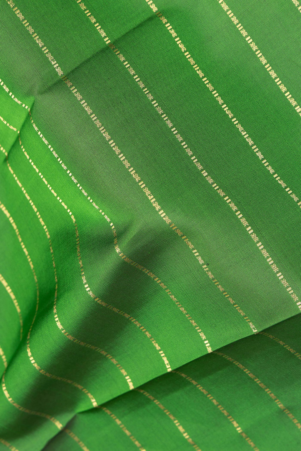 Close up of Pure Silk Green Kanjivaram Saree with Stripes on the body and Zari Border.  displaying folds
