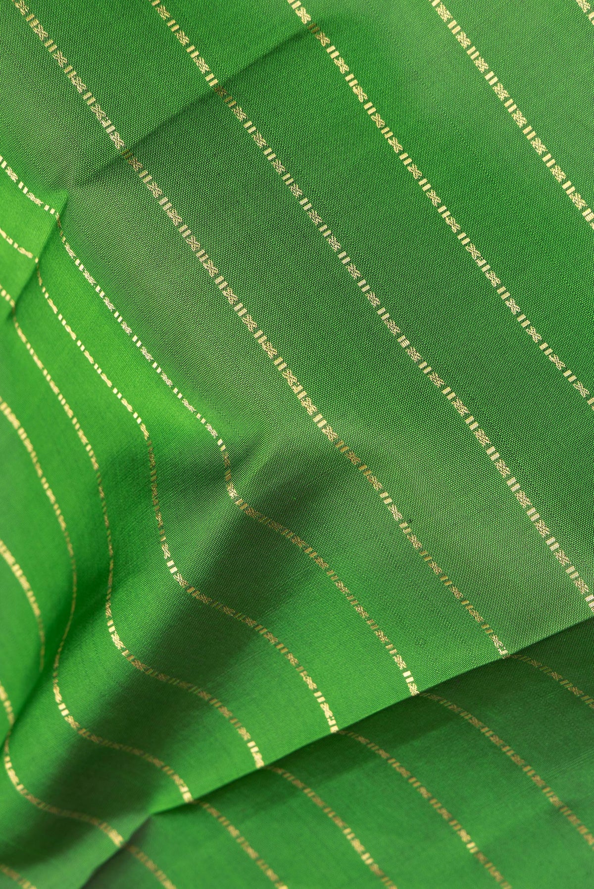 Close up of Pure Silk Green Kanjivaram Saree with Stripes on the body and Zari Border.  displaying folds