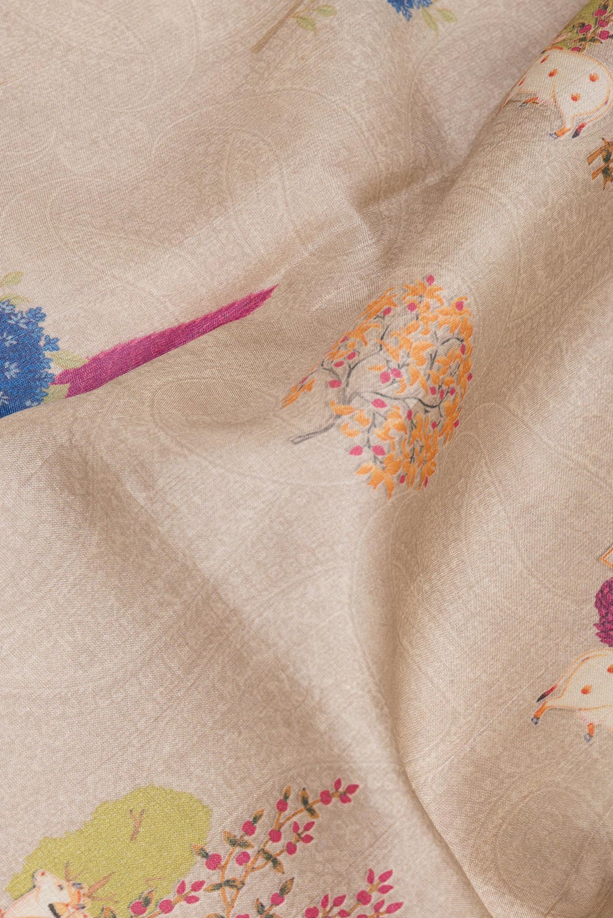 Close up of Beige Tussar Saree with Printed design on the body and Printed Border.  displaying folds