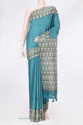 Peacock Blue Tussar Silk Saree with Checked design on the body and Printed Border.  displayed on a mannequin