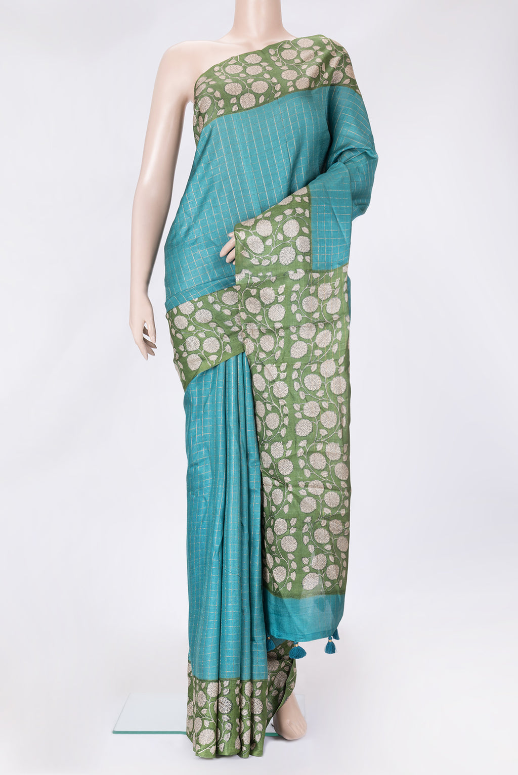Peacock Blue Dual Tone Tussar Silk Saree with Printed design on the body and Zari Border.  displayed on a mannequin