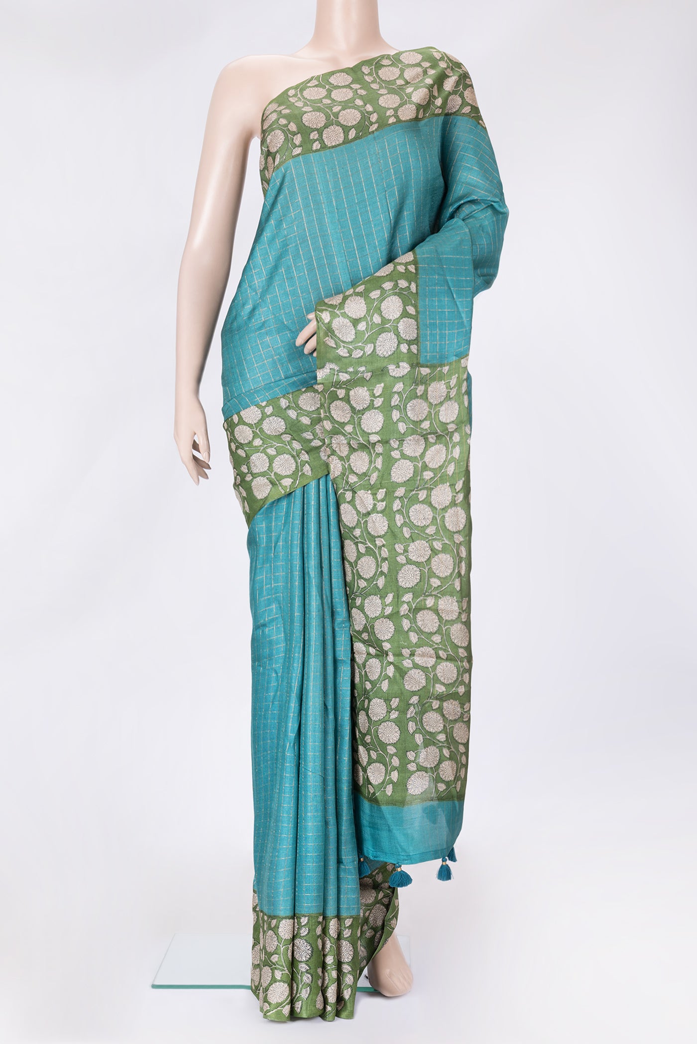 Peacock Blue Dual Tone Tussar Silk Saree with Printed design on the body and Zari Border.  displayed on a mannequin