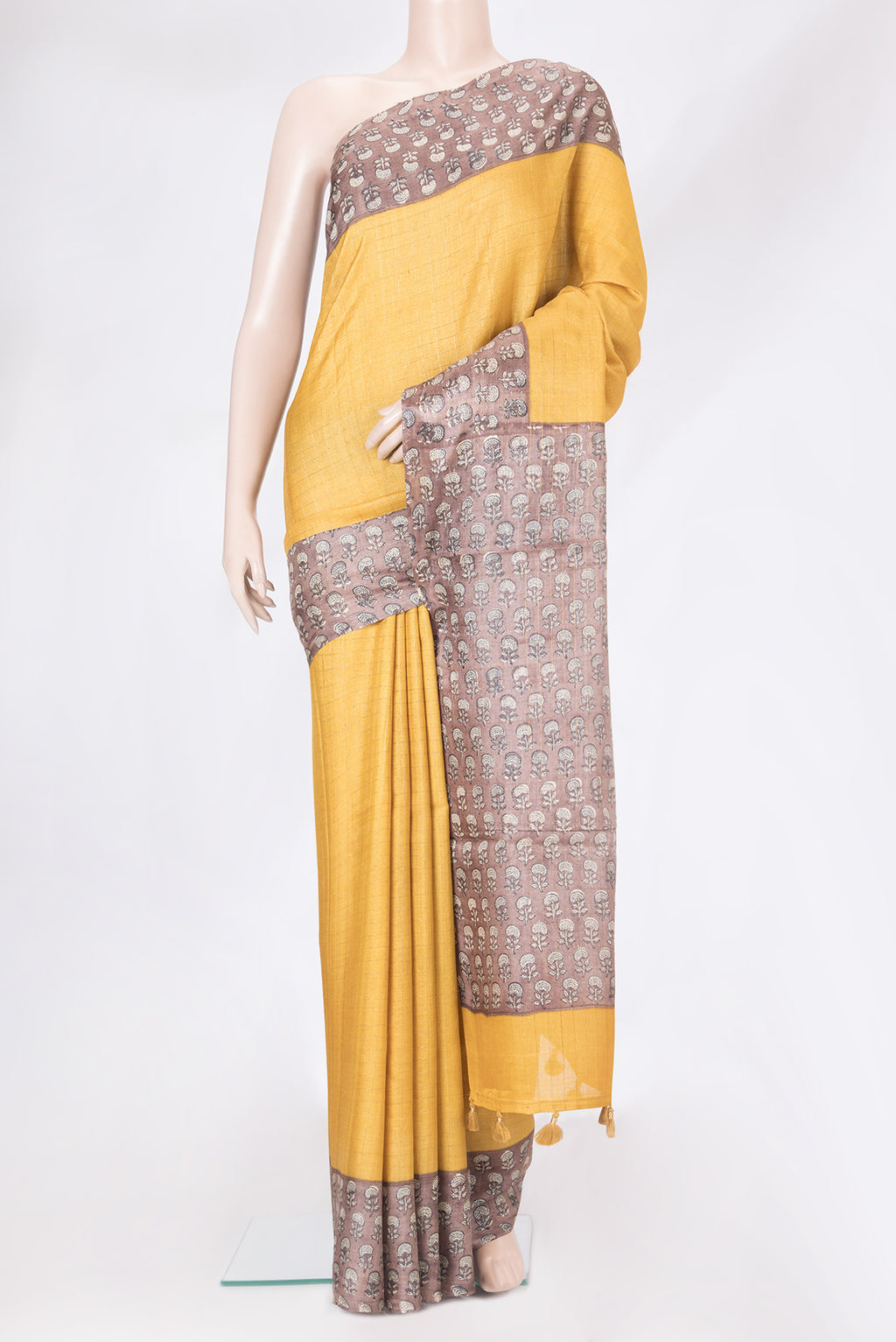 Mustard Tussar Silk Saree with Checked design on the body and Printed Border.  displayed on a mannequin