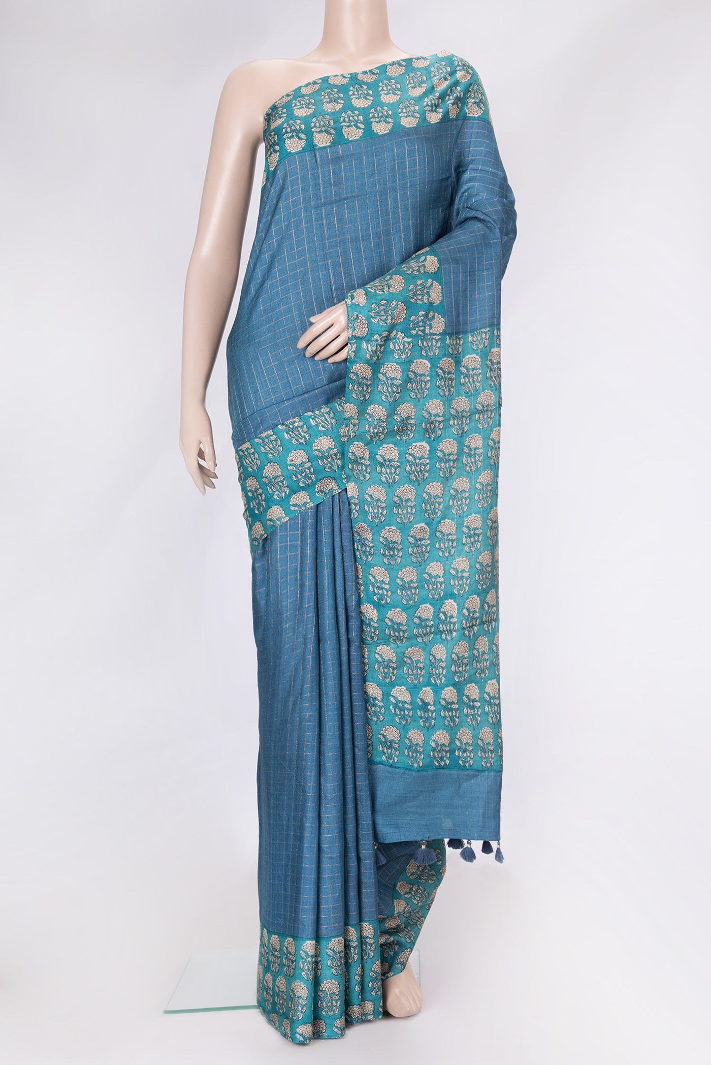 Peacock Blue Dual Tone Tussar Silk Saree with Checked design on the body and Printed Border.  displayed on a mannequin