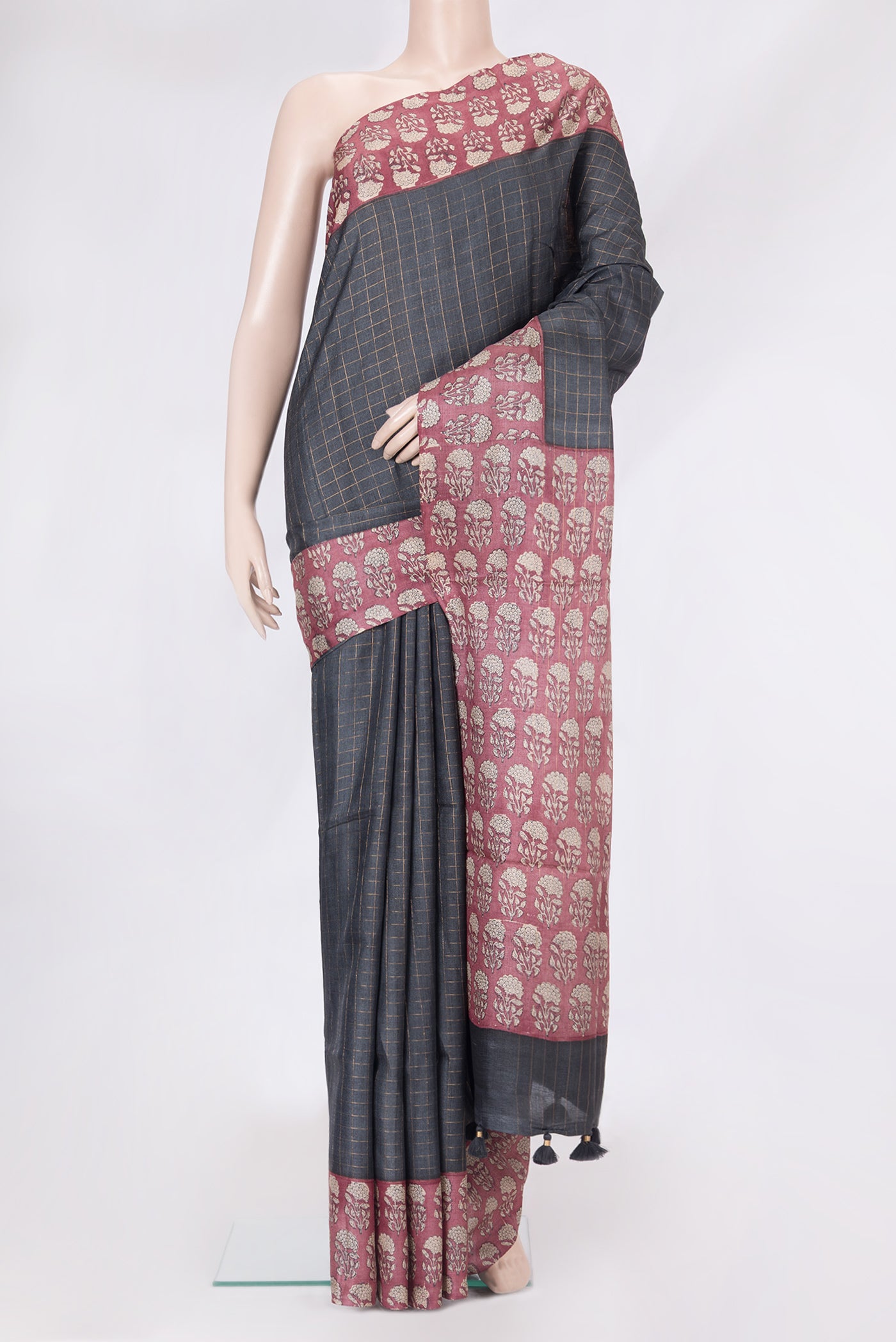 Grey Tussar Silk Saree with Checked design on the body and Printed Border.  displayed on a mannequin