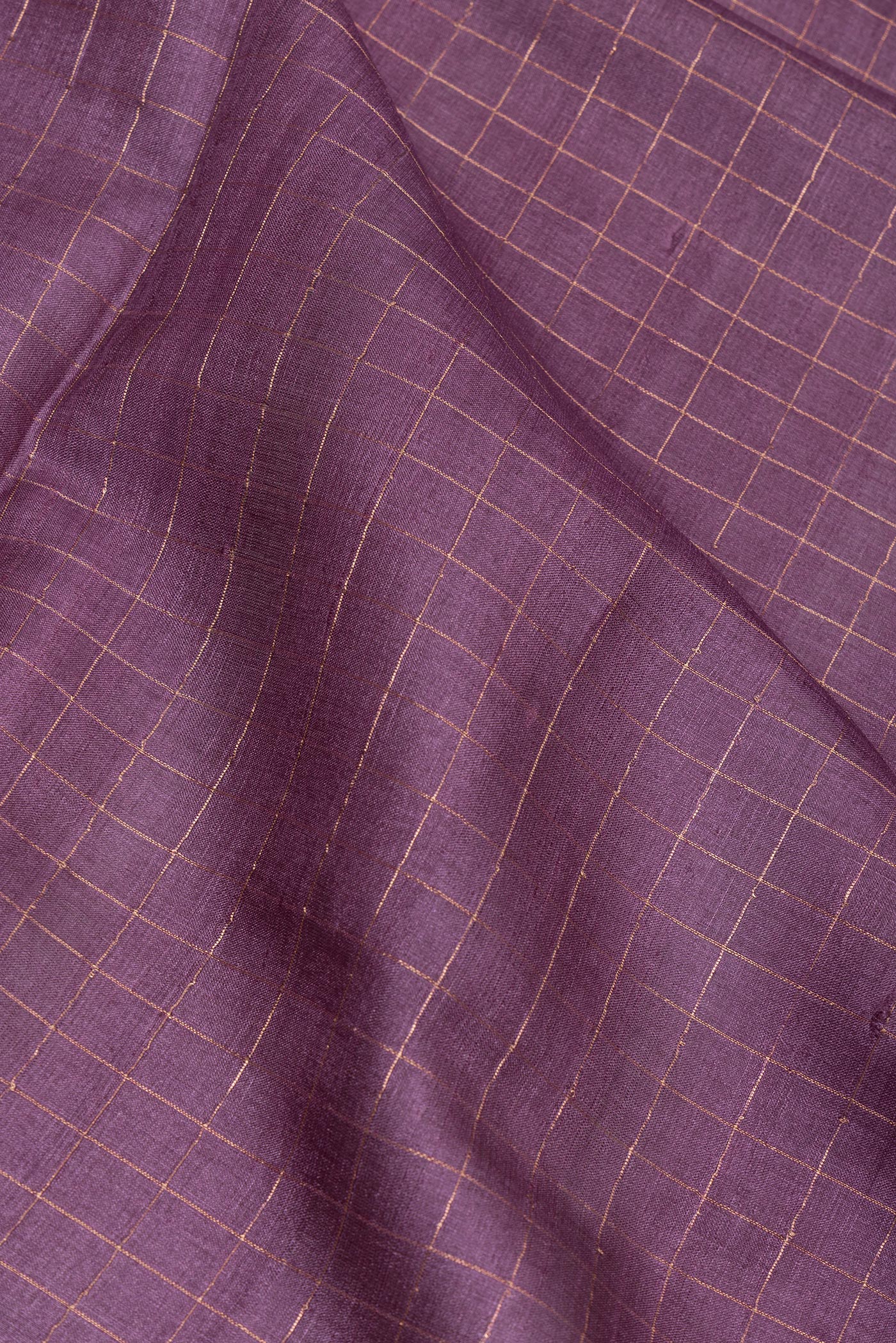Close up of Purple Tussar Silk Saree with Checked design on the body and Printed Border.  displaying folds
