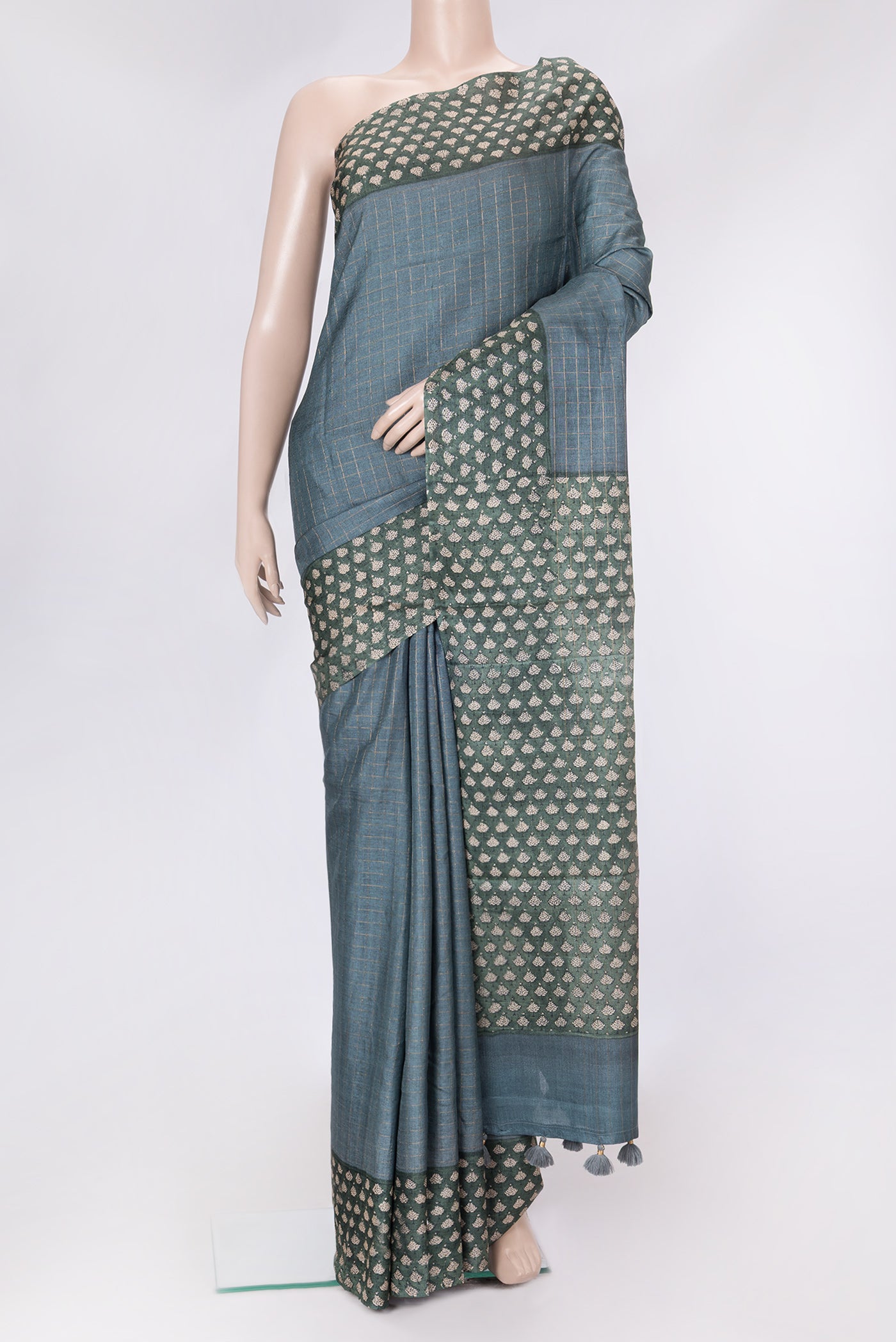 Grey Dual Tone Tussar Silk Saree with Checked design on the body and Printed Border.  displayed on a mannequin