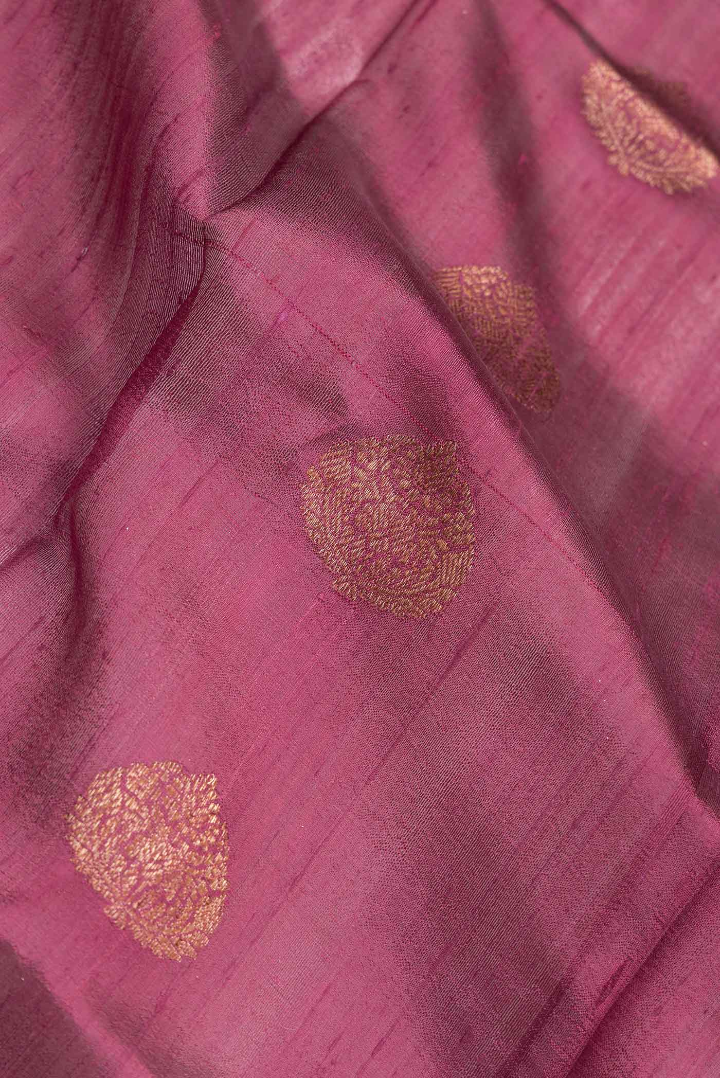 Close up of Maroon Dual Tone Tussar Saree with Zari Butta on the body and Zari Border.  displaying folds