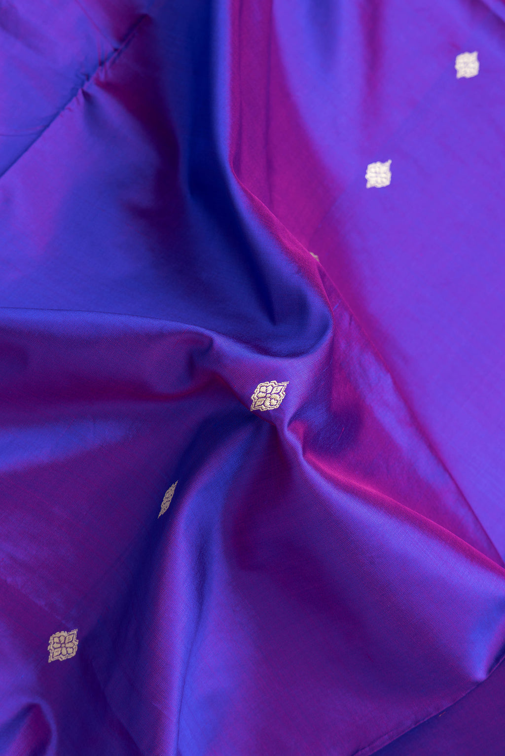 Close up of Purple Dual Tone Banarasi Silk Saree with Thread Butta on the body and Thread Border.  displaying folds