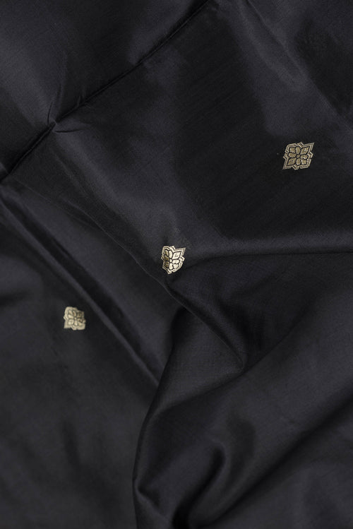 Close up of Black Dual Tone Banarasi Silk Saree with Thread Butta on the body and Thread Border.  displaying folds