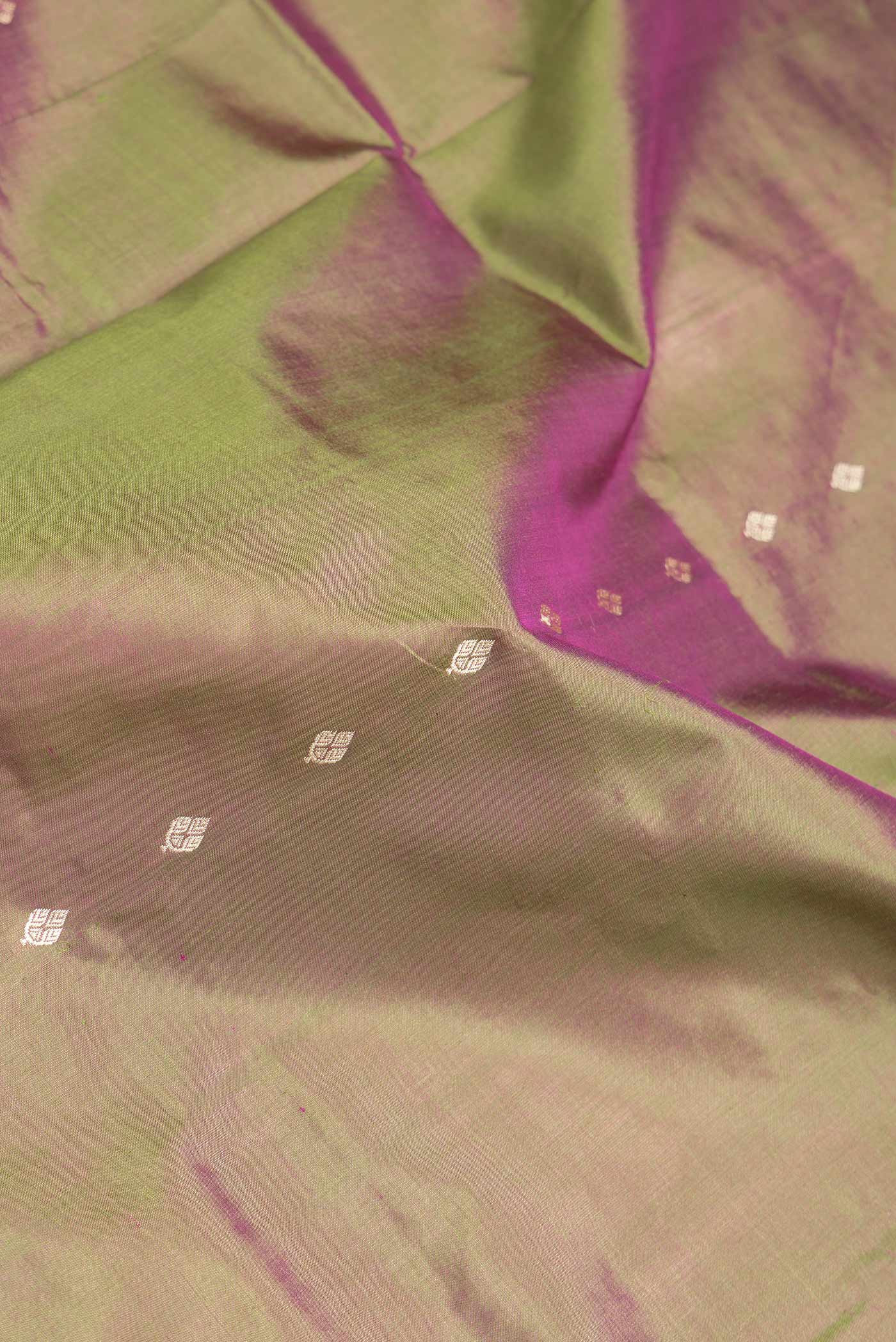 Close up of Mehandi Green Dual Tone Banarasi Silk Saree with Thread Butta on the body and Thread Border.  displaying folds