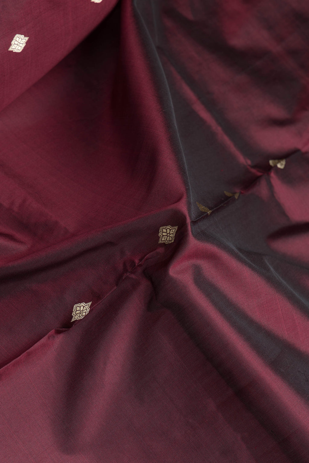Close up of Brown Dual Tone Banarasi Silk Saree with Thread Butta on the body and Thread Border.  displaying folds