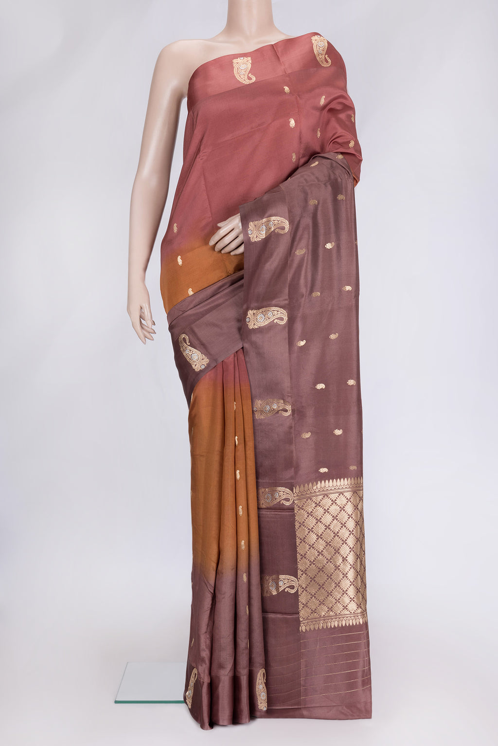 Brown and Bronze Color Tussar Silk Saree with Zari Butta on the body and Fancy Border.  displayed on a mannequin