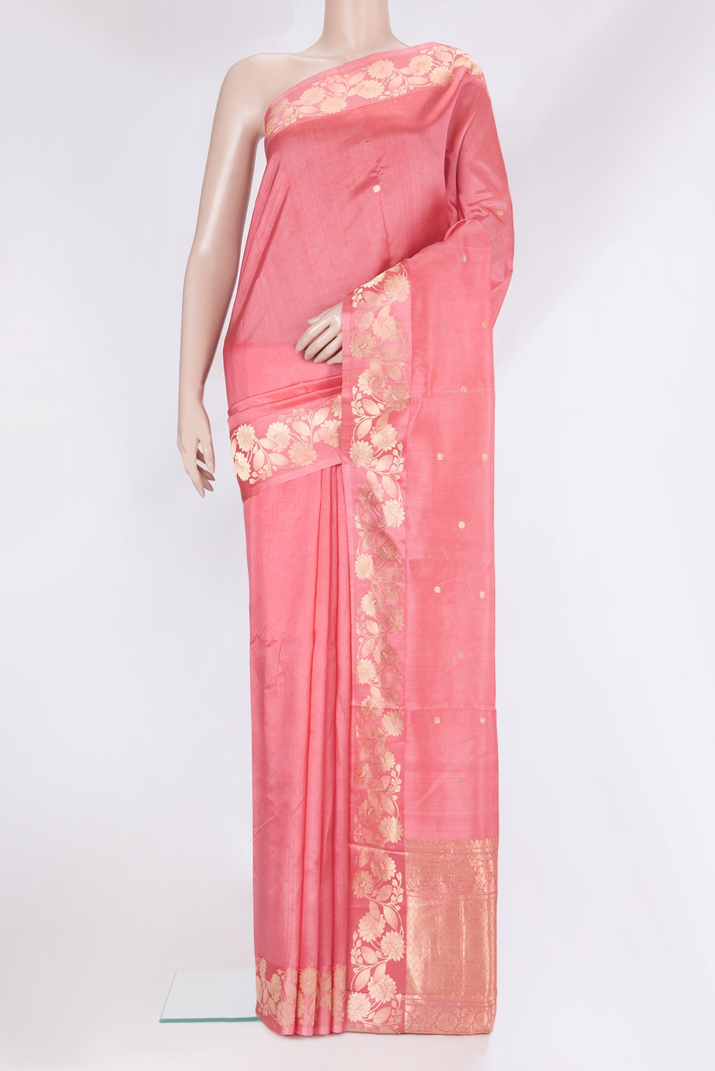 Coral Tussar Silk Saree with Zari Butta on the body and Fancy Border.  displayed on a mannequin