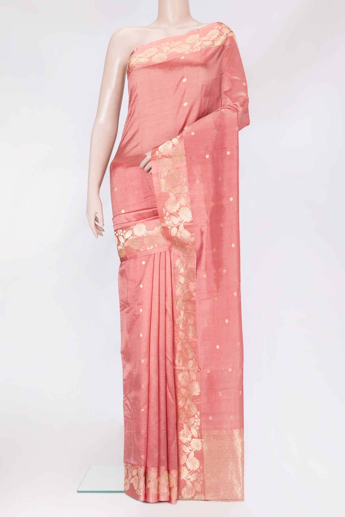 Peach Tussar Silk Saree with Zari Butta on the body and Fancy Border.  displayed on a mannequin