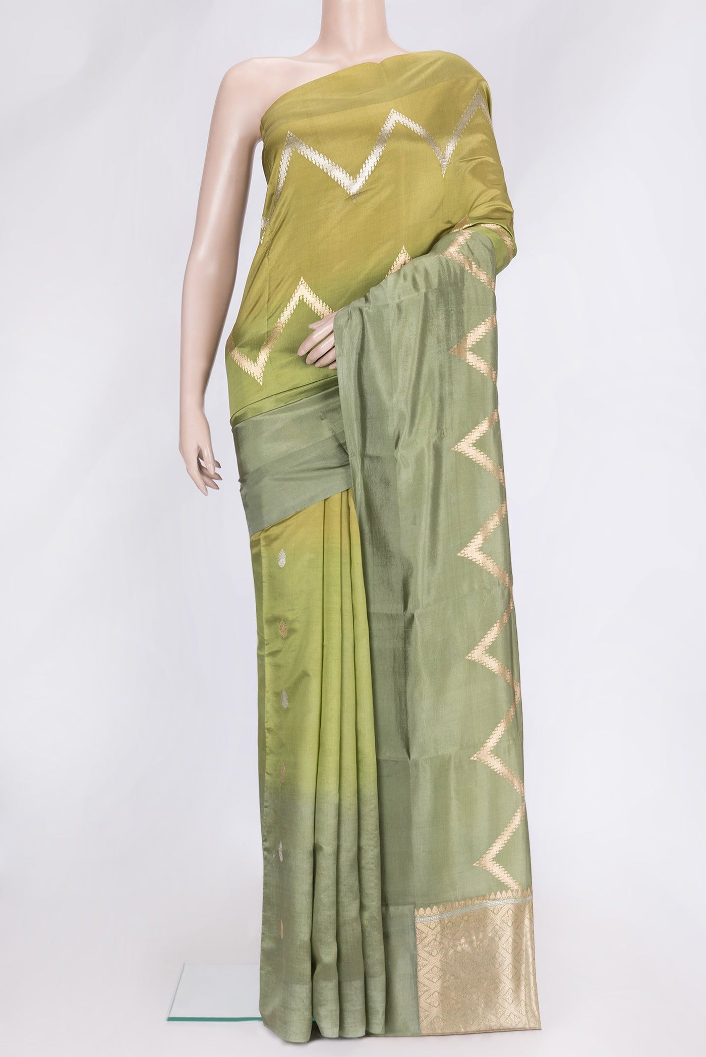 Pista Green Dual Tone Tussar Silk Saree with Zig Zag design on the body and Plain Border.  displayed on a mannequin