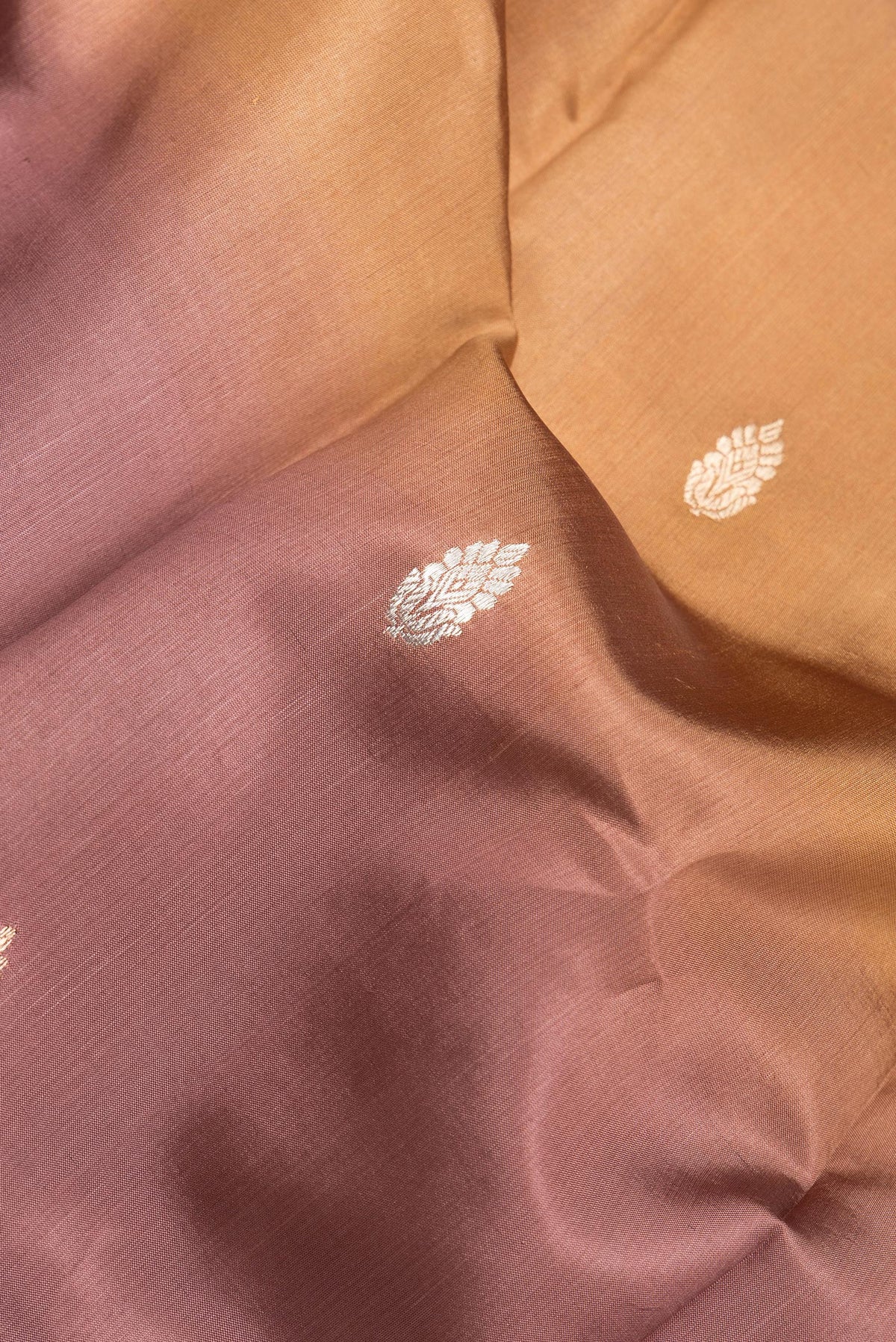 Close up of Brown Dual Tone Tussar Silk Saree with Stripes on the body and Plain Border.  displaying folds