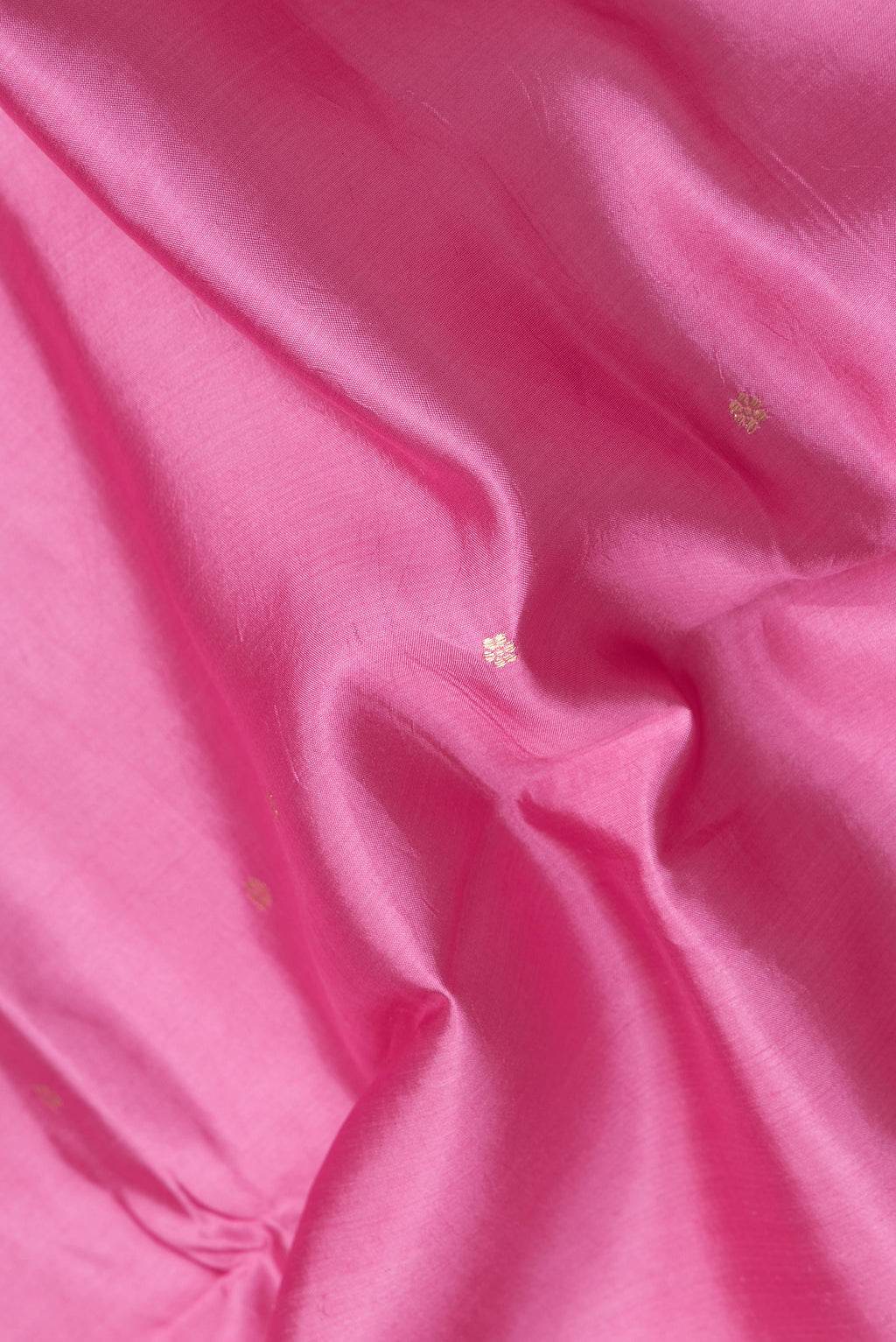 Close up of Pink Dual Tone Banarasi Katan Silk Saree with Zari Butta on the body and Fancy Border.  displaying folds
