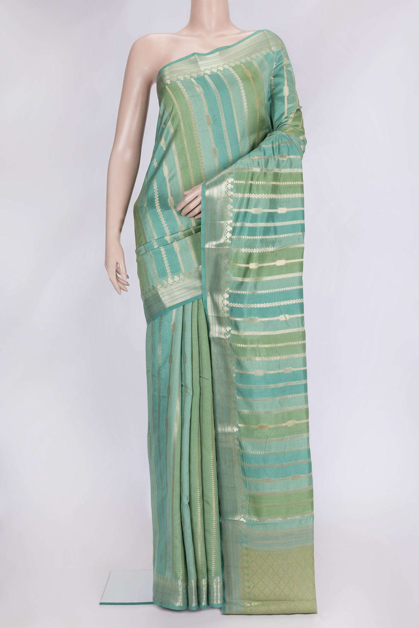 Pista Green Dual Tone Tussar Silk Saree with Stripes on the body and Zari Border.  displayed on a mannequin