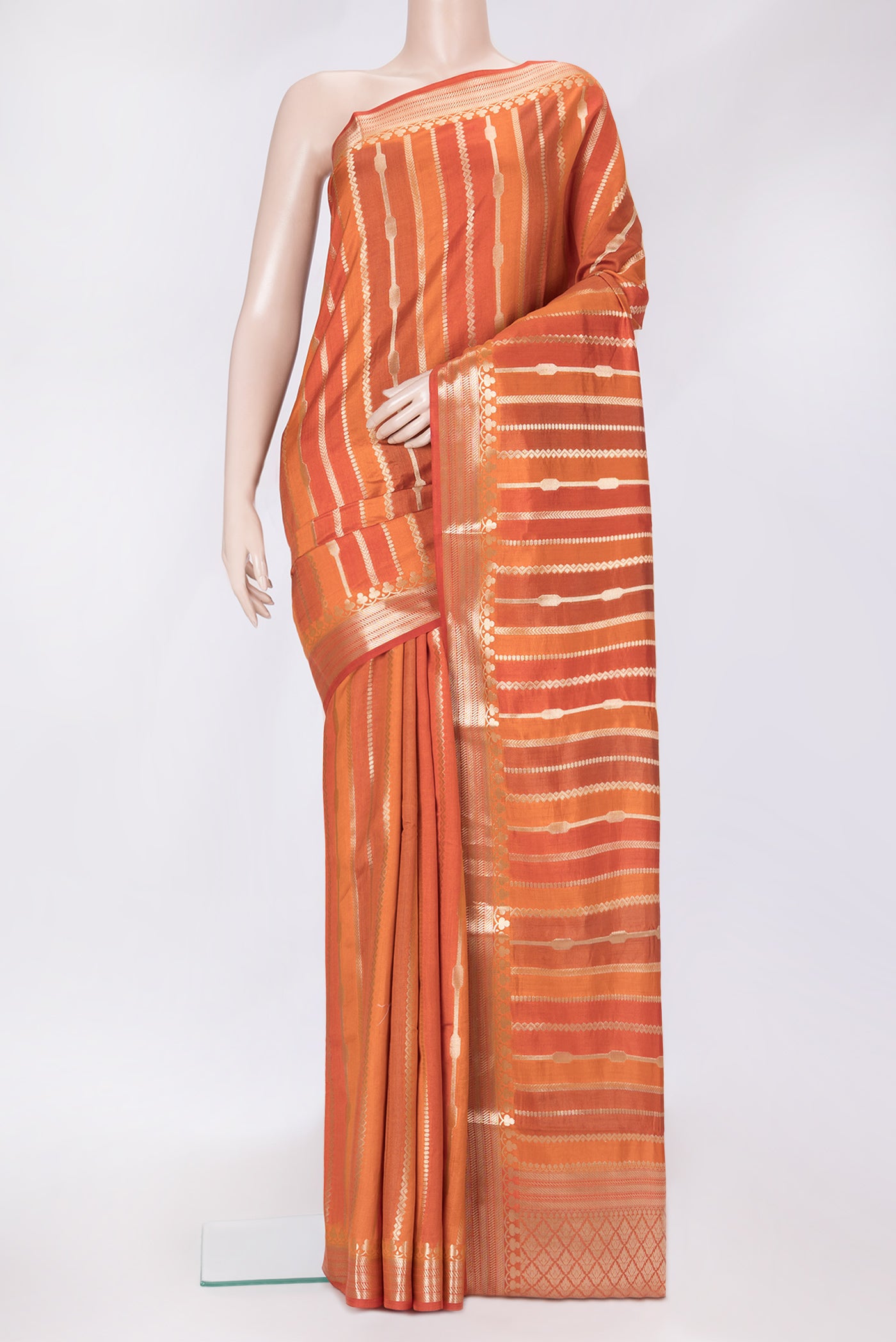 Orange Dual Tone Tussar Silk Saree with Stripes on the body and Zari Border.  displayed on a mannequin
