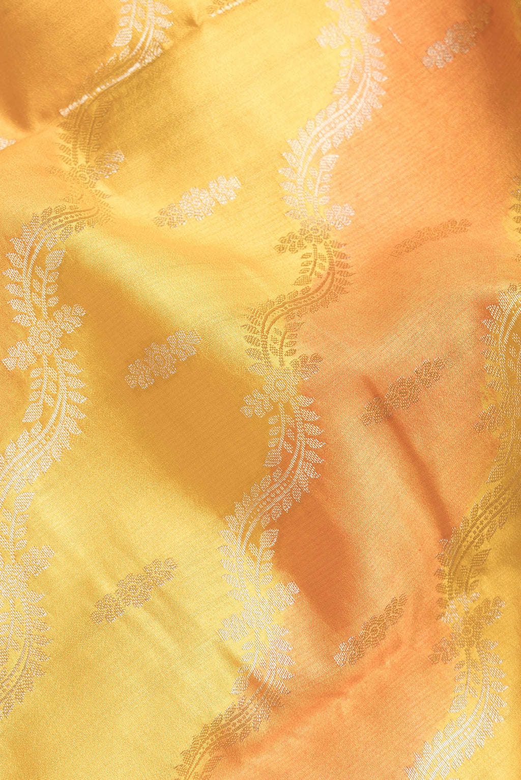 Close up of Yellow Dual Tone Banarasi Katan Silk Saree with Zari Brocade on the body and Zari Border.  displaying folds