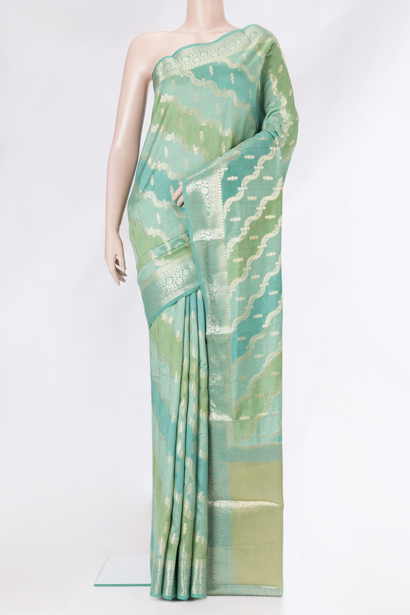 Green Dual Tone Banarasi Raw Silk Saree with Zari Brocade on the body and Zari Border.  displayed on a mannequin