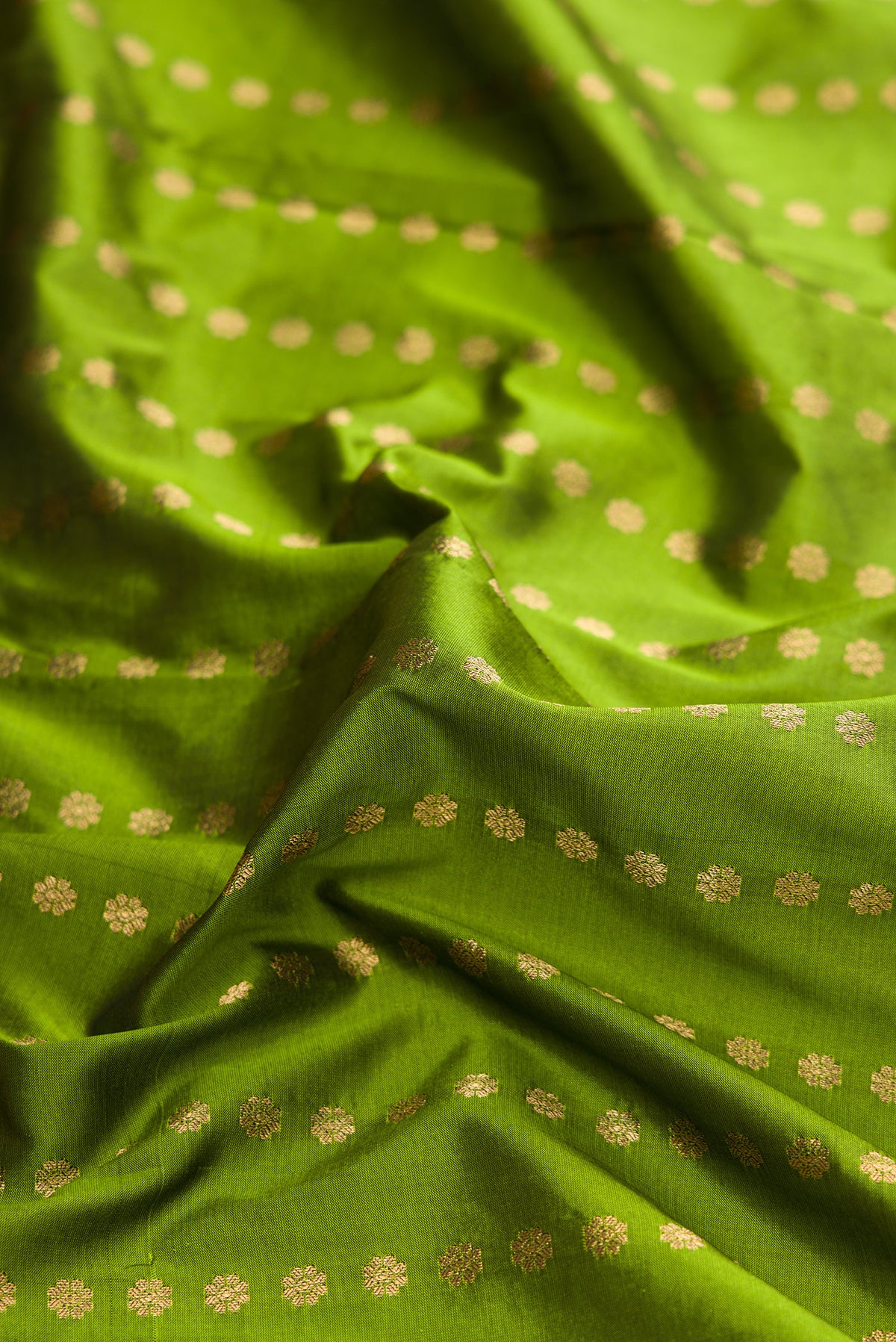 Close up of Green Dual Tone Gadwal Silk Saree with Stripes on the body and Zari Border.  displaying folds